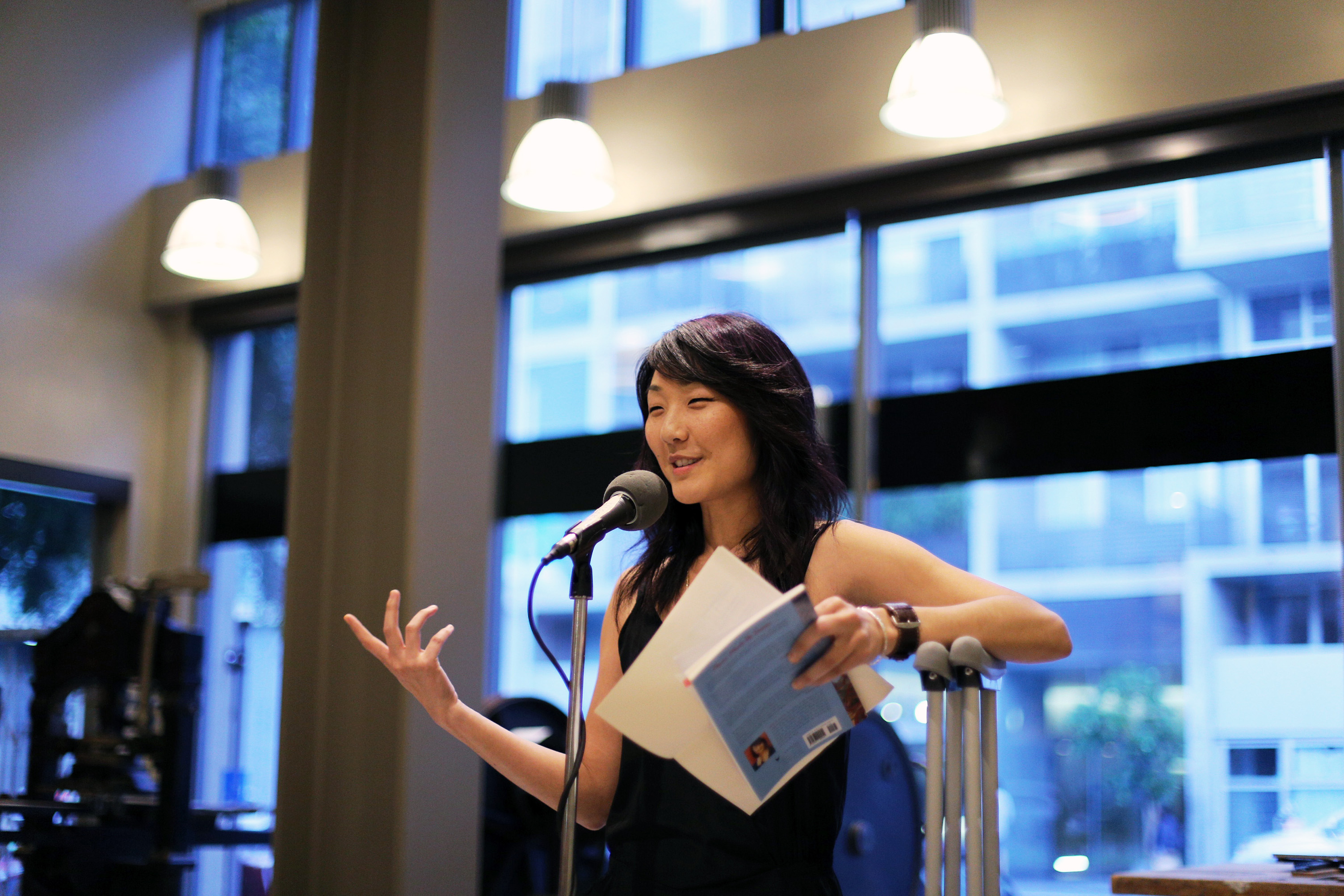 Grace under fire. Brynn Saito reads at the American Bookbinders Museum despite an injured hip