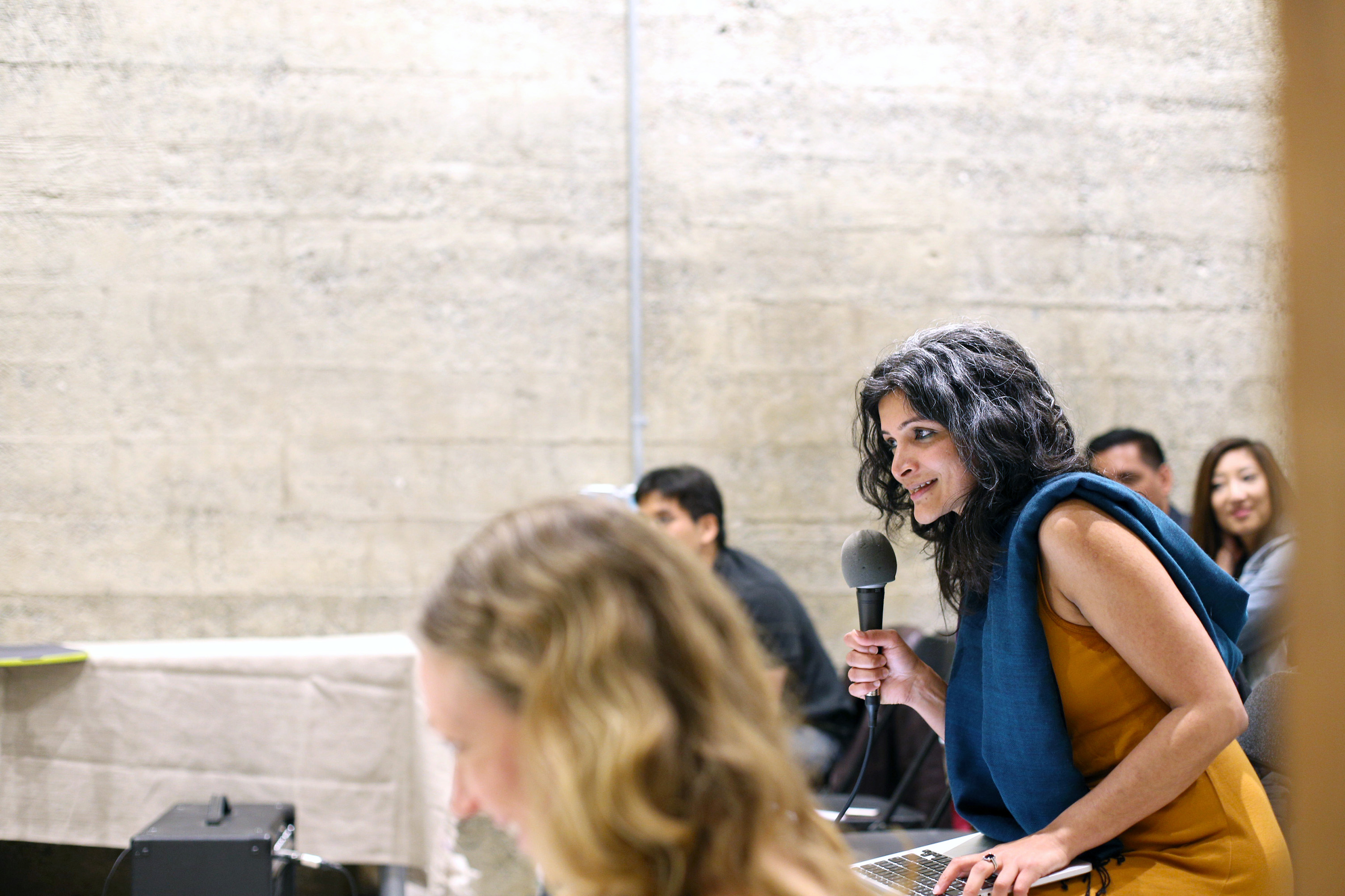 Monica Mody sits among the audience during her performance at the American Bookbinders Museum and invites them to complete the fabric of a poem together in a collaborative act of healing and remembrance for voices that have been silenced and stories that are yet untold.