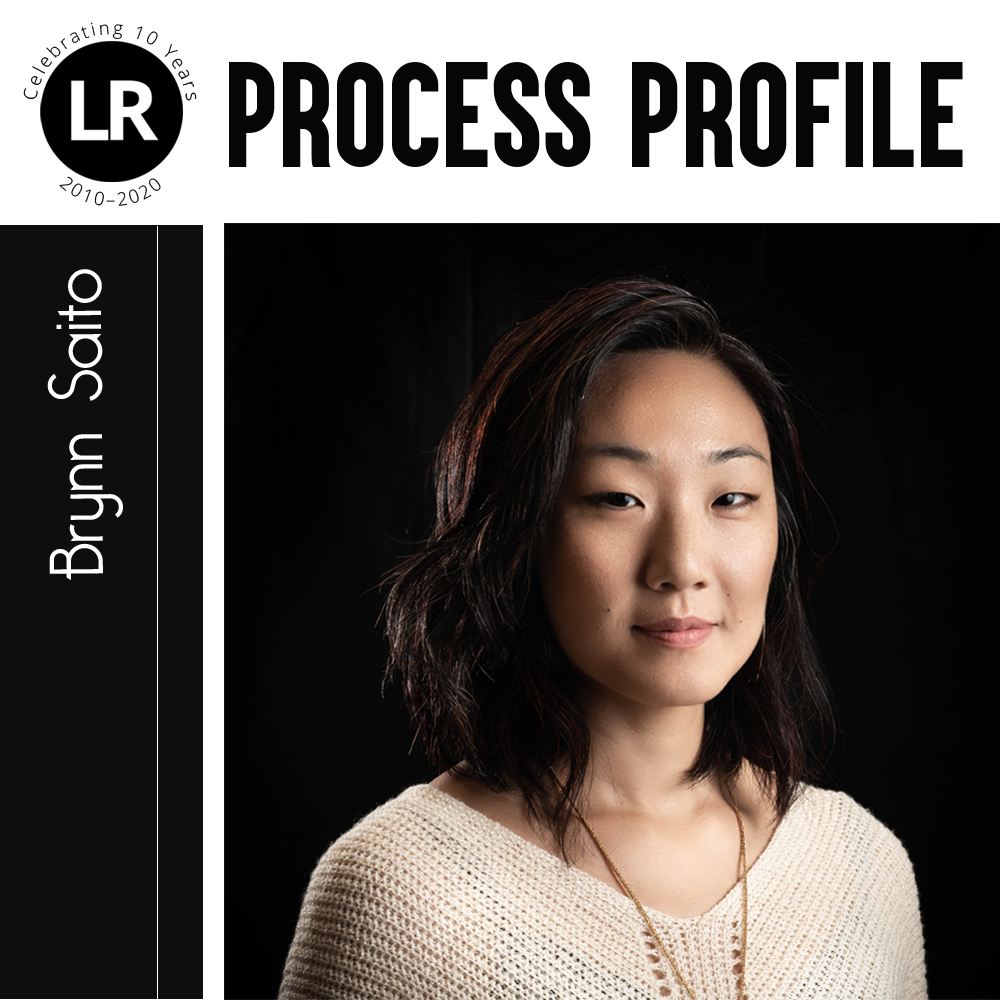 LR: Celebrating 10 Years, 2010–2020; Process Profile: Brynn Saito. Photograph of Brynn Saito (Asian American poet with shoulder-length hair standing at a 3/4 angle against a black background)